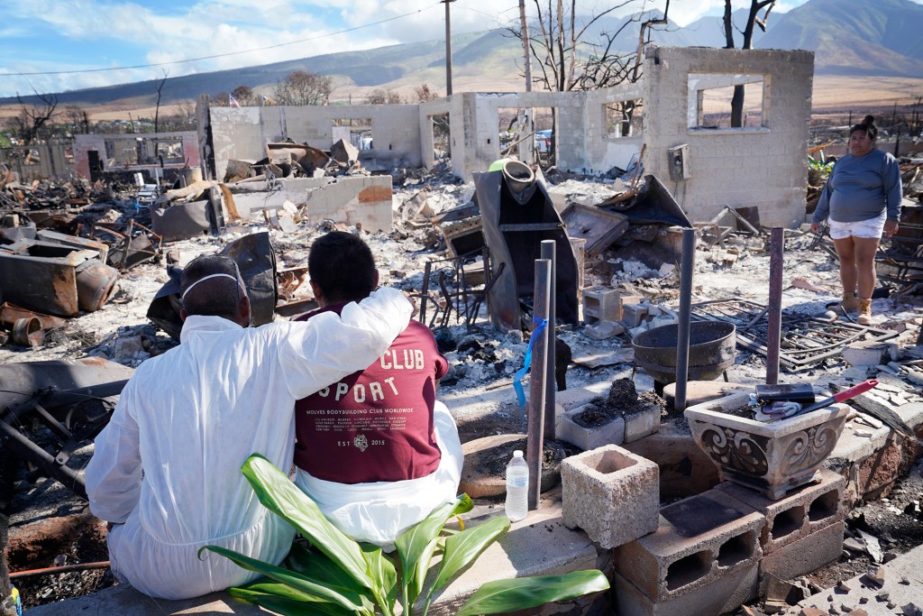 Mario Siatris, from left, and adult children Devin Siatris and Camille Siatris wrap up sifting through their home Monday, Nov. 13, 2023, in Lahaina. Their homes and neighborhood were destroyed in the Aug. 8 fire. (Kevin Fujii/Civil Beat/2023)