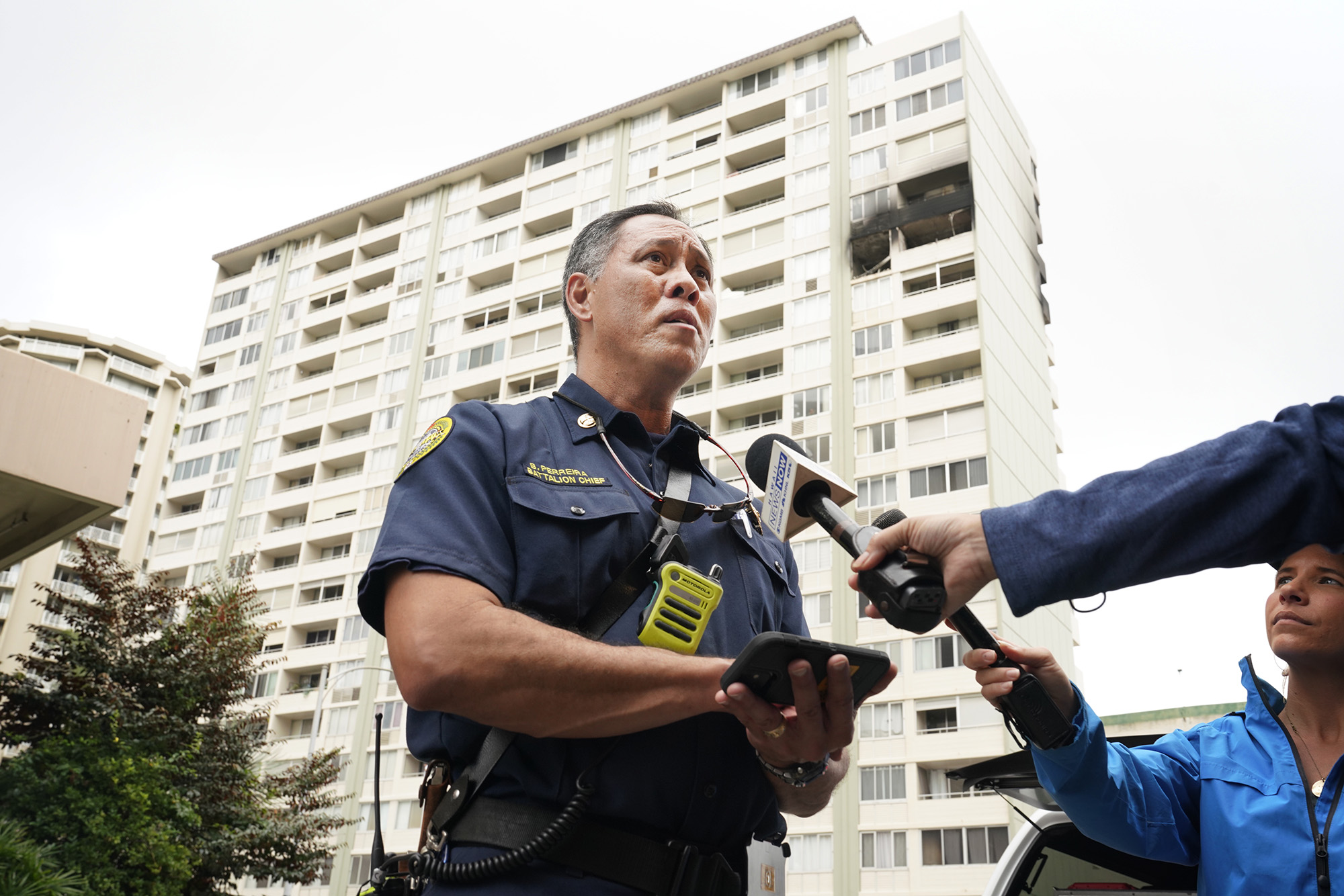 Honolulu Fire Department Battalion Chief Brady Perreira talks with the media after extinguishing the Wood Rose Apartment fire at 780 Amana St. Thursday, Nov. 30, 2023, in Honolulu. The fire burned an apartment on the 14th floor. (Kevin Fujii/Civil Beat/2023)