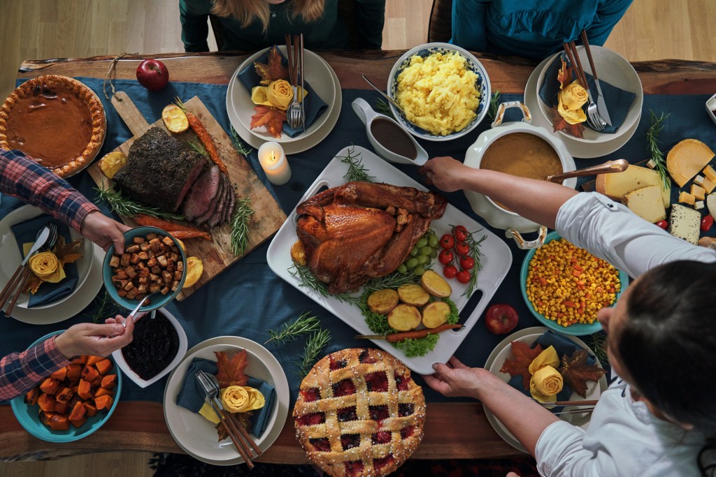 Stuffed Turkey dinner table Thanksgiving Holidays with Pumpkin, Peas, Pecan, Berry Pie, Cheese Denby Fawcett column