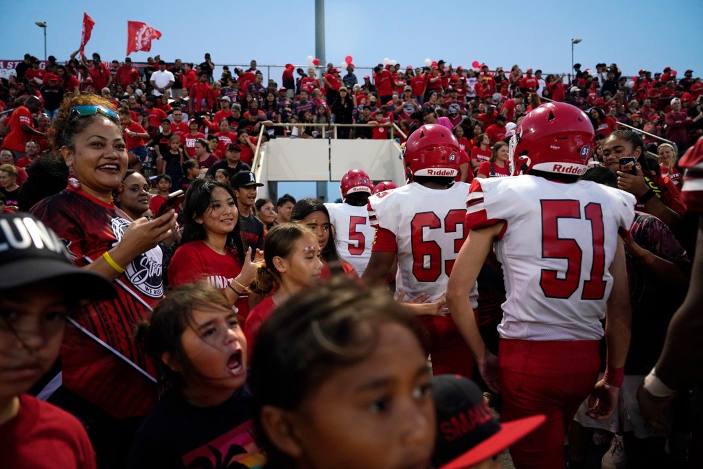 Lahainaluna High School fans celebrate the junior varsity team’s win after their first football game Saturday, Sept. 30, 2023, at War Memorial Stadium in Kahului. The sold-out game paves the little way slowly back to normalcy after the devastating Aug. 8 fire. (Kevin Fujii/Civil Beat/2023)
