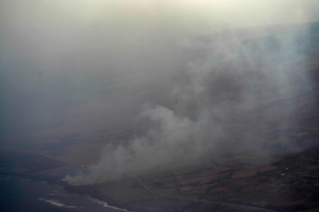 Smoke rises from Lahaina on the morning of Aug. 9, 2023, the day after wildfires destroyed much of the historic West Maui town. (Ku’u Kahuanoe/Civil Beat/2023)