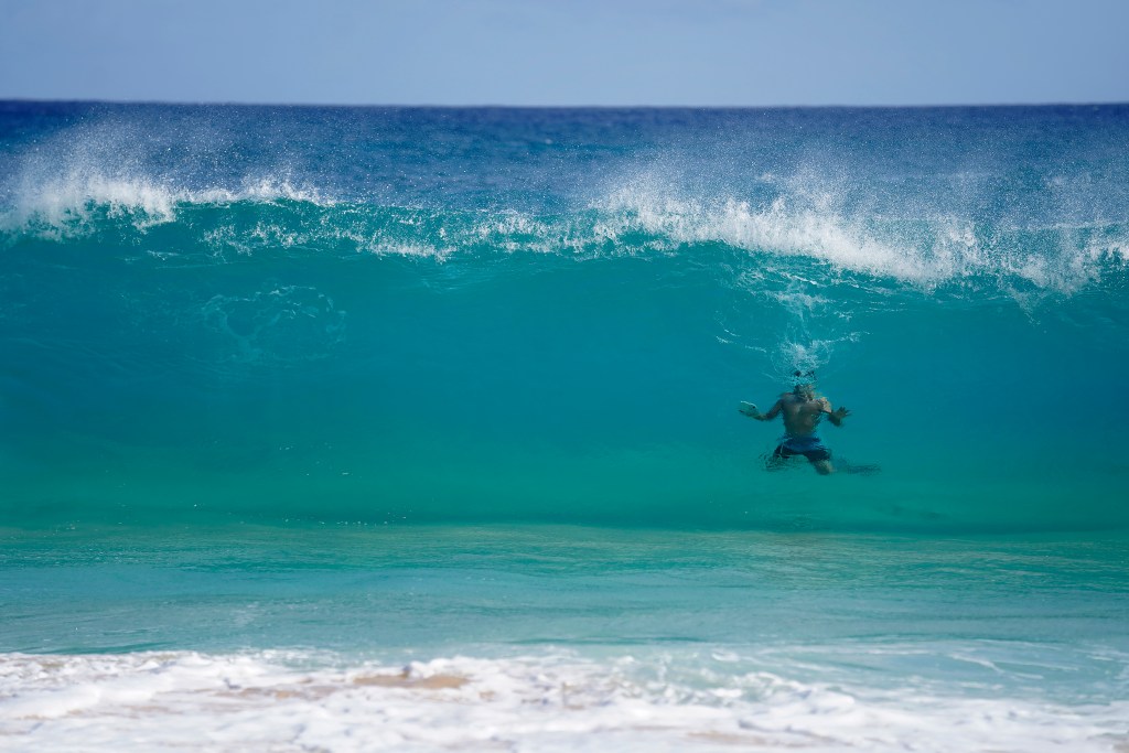 A bodysurfer floats in a wall of water Monday, Oct. 2, 2023, at Sandy Beach in Honolulu. Despite a forecast of 1 to 3 foot waves, this infamous body and boogie boarding beach is always much larger than predicted. Honolulu Ocean Safety and Lifeguard Services Division report an average of 800 rescues a year at Sand Beach Park. More rescues happen here than any other beach in the island state.