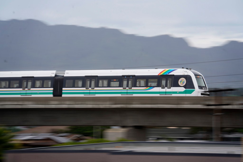 The Skyline train heads toward Aloha Stadium Friday, Dec. 1, 2023, as seen from Waipahu High School. (Kevin Fujii/Civil Beat/2023)