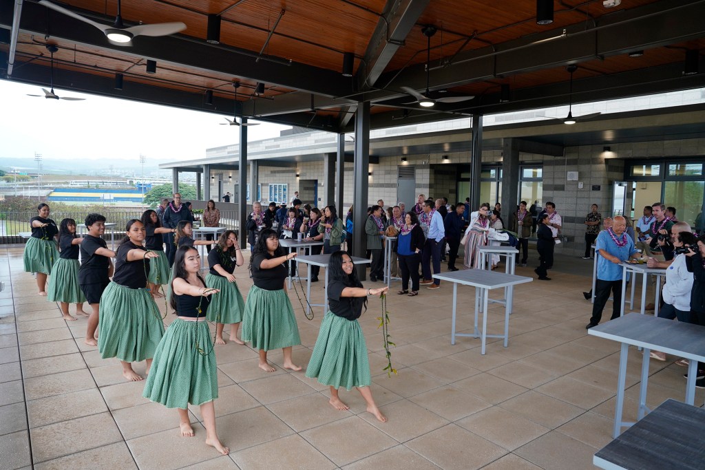The Hula 2 and 3 class performs during the blessing of the Waipahu High School Integrated Academy Learning Center  Friday, Dec. 1, 2023, in Waipahu. The center offers students the opportunity to learn trades and skills. (Kevin Fujii/Civil Beat/2023)