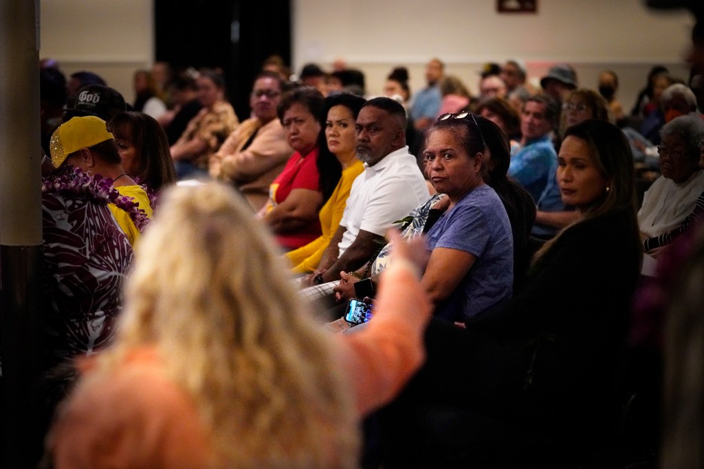 West Side town hall meeting attendees look toward a woman speaking out of turn Tuesday, Dec. 5, 2023, in Waianae. This woman was angry about halfway houses so close to her home. Recent acts of violence, halfway houses and illegal game rooms highlighted concerns of West Oahu citizens. (Kevin Fujii/Civil Beat/2023)