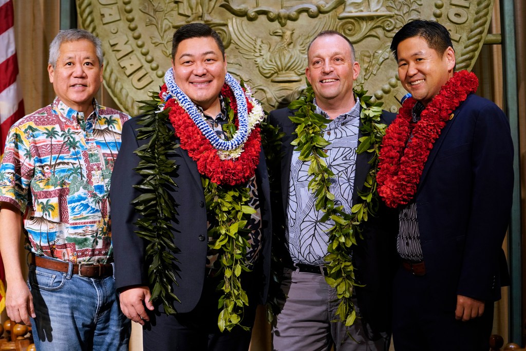 House Speaker Scott Sakai, from left, Rep. Tyson Miyake, Gov. Josh Green and Senator Troy Hashimoto pose for a photo Friday, Dec. 15, 2023, in Honolulu. (Kevin Fujii/Civil Beat/2023)