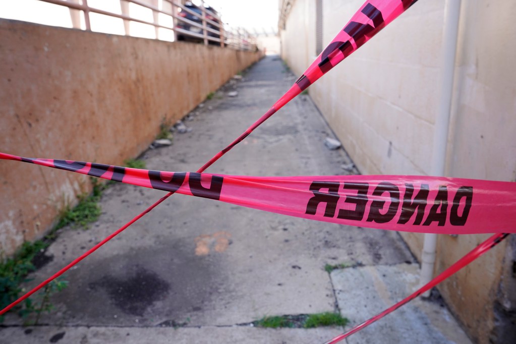 A walkway is blocked with tape where concrete pieces from the top of Farrington High School’s swimming-pool bleachers fell into a walkway photographed Friday, Dec. 29, 2023, in Honolulu. Lack of CIP funding for repairs and renovations have created a safety hazard for students, faculty, staff and visitors. (Kevin Fujii/Civil Beat/2023)