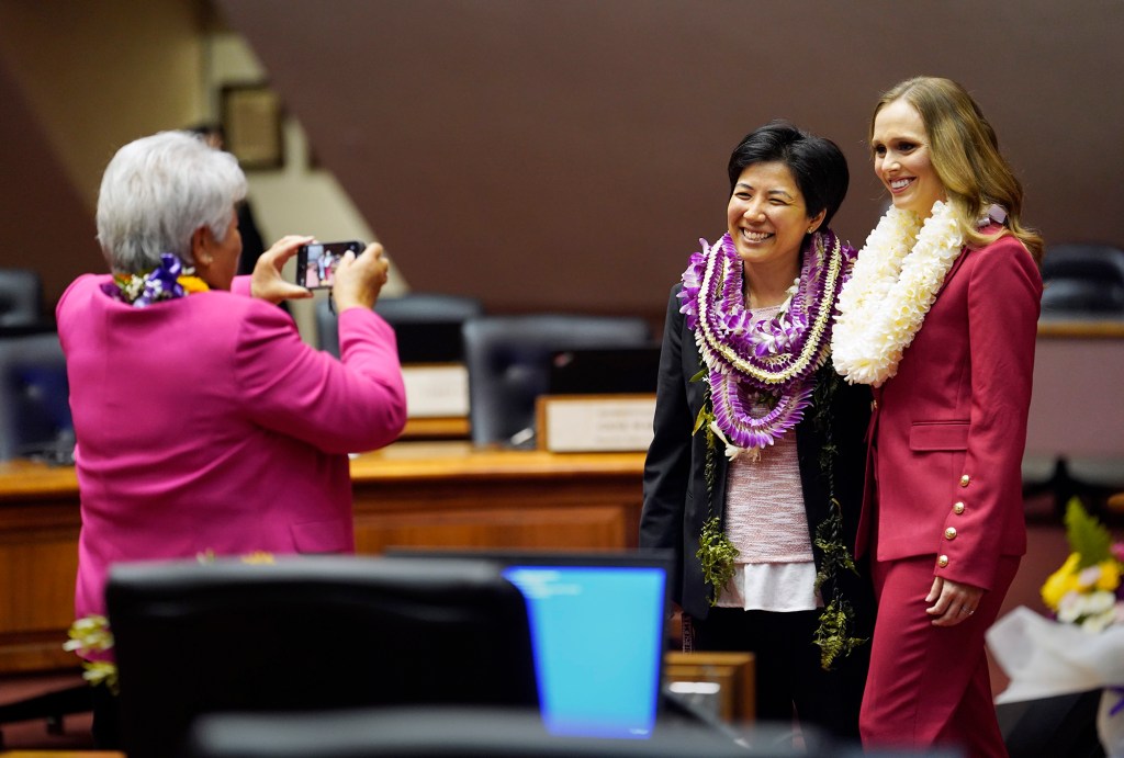 The House of Representatives majority floor leader Dee Morikawa, from left, takes a photo of Linda Ichiyama and  minority leader Lauren Matsumoto before the opening of the legislative session Wednesday, Jan. 17, 2024, in Honolulu. (Kevin Fujii/Civil Beat/2024)