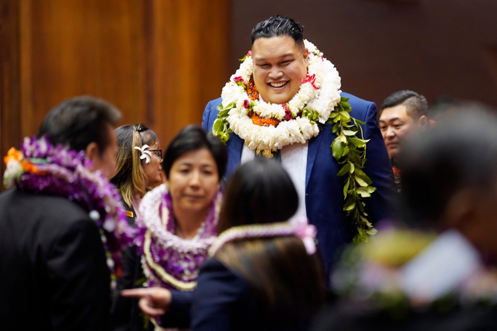 The House of Representatives Darius Kila towers over his colleagues before the opening of the legislative session Wednesday, Jan. 17, 2024, in Honolulu. (Kevin Fujii/Civil Beat/2024)