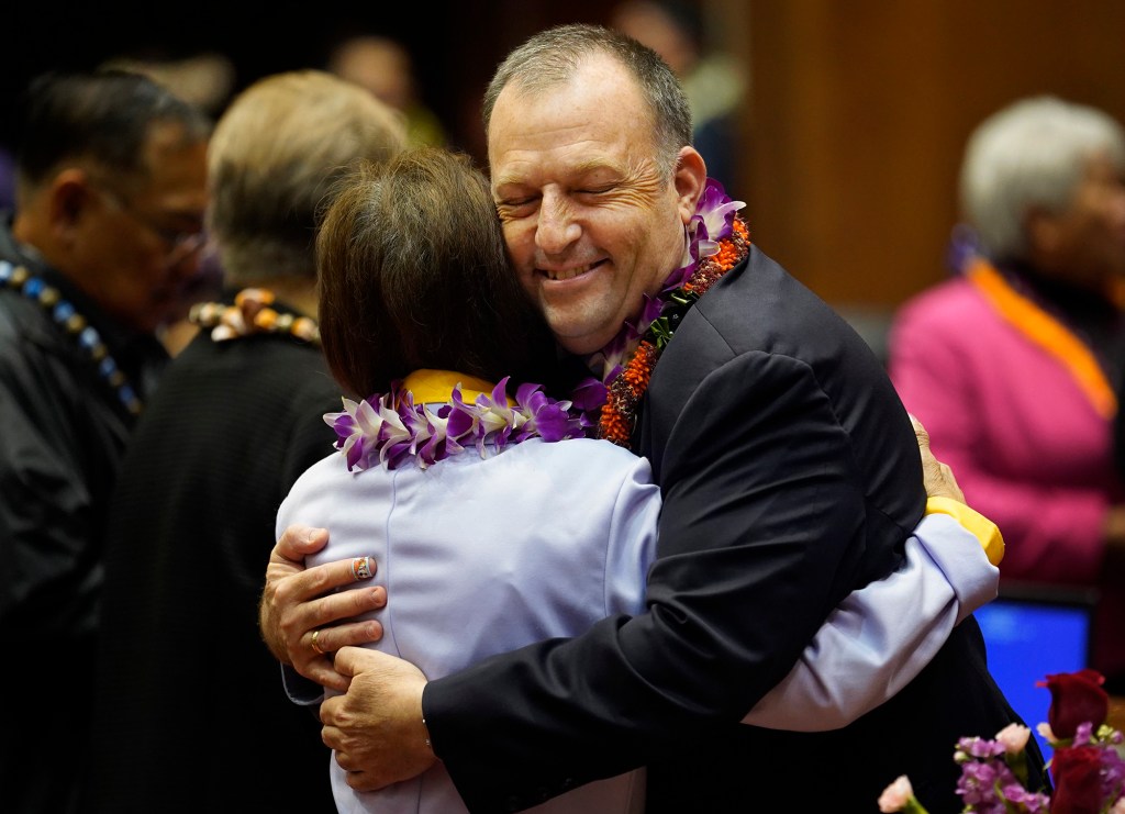 The House of Representatives member Rose Martinez hugs Gov. Josh Green during a break in the opening of the legislative session Wednesday, Jan. 17, 2024, in Honolulu. (Kevin Fujii/Civil Beat/2024)