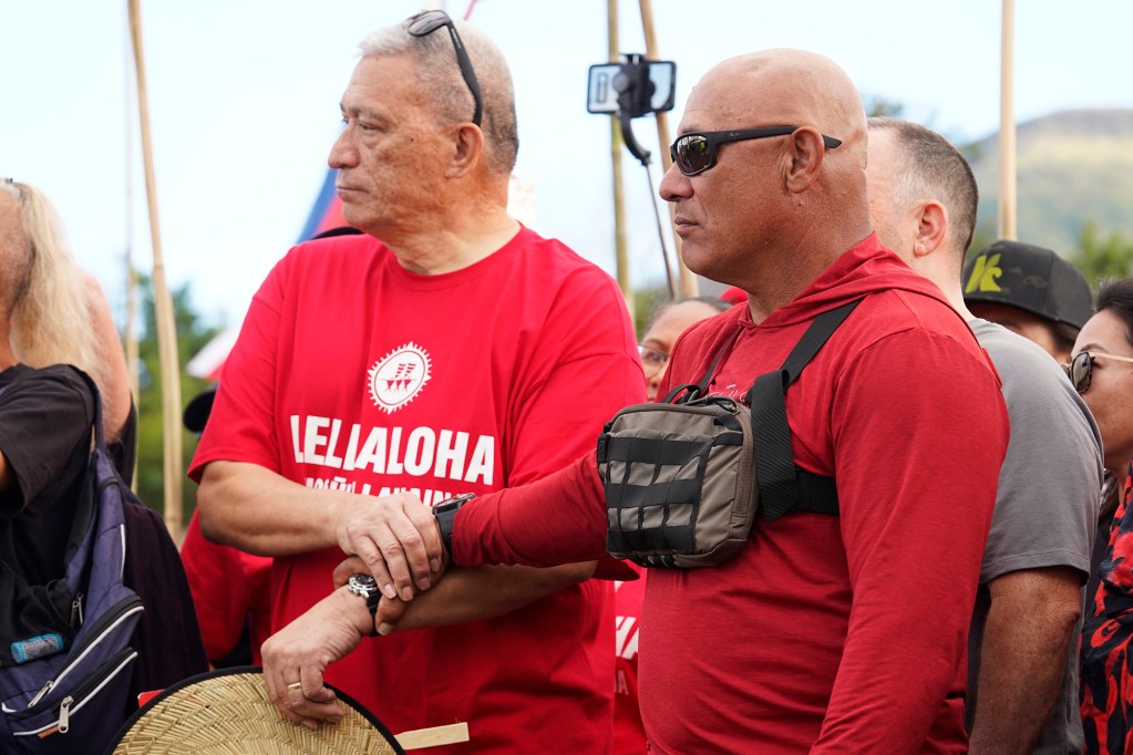 Maui Mayor Richard Bissen and organizer Uncle Archie Kalepa share a moment during the Hoʻūlu Lahaina Unity Walk Saturday, Jan. 20, 2024, in Lahaina. Uncle Archie Kalepa organized the Lele Aloha group to bring the diverse people of Lahaina together after the devastating Aug. 8 fire destroyed the historic West Maui town. (Kevin Fujii/Civil Beat/2024)