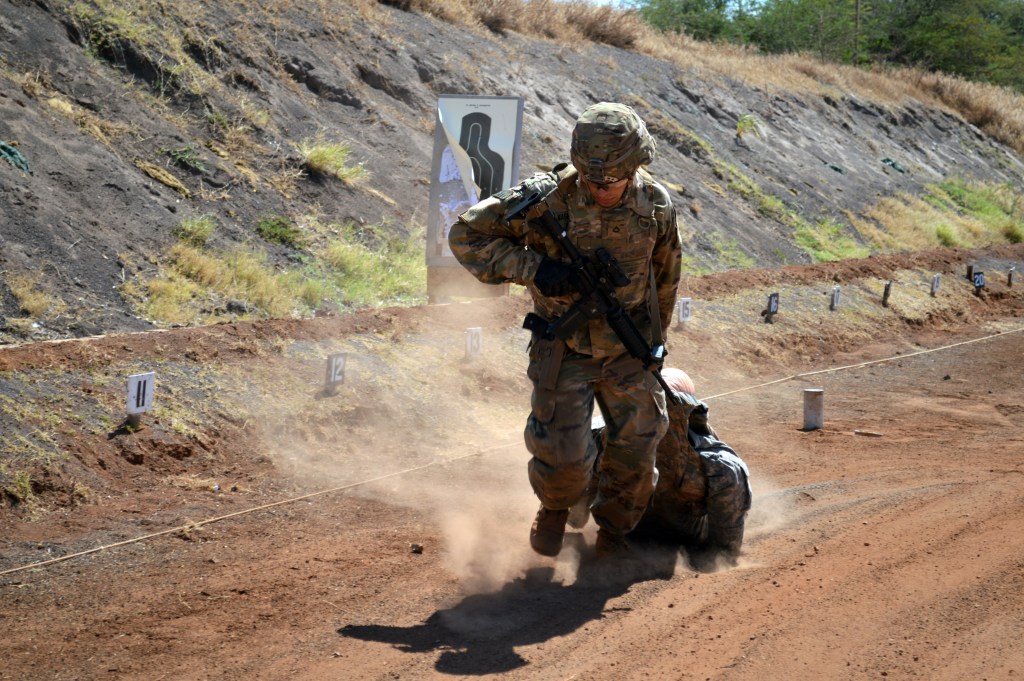 Pfc. Marcus Washington, a combat engineer to the 29th Brigade Engineer Battalion, 3rd Brigade Combat Team, 25th Infantry Division, drags a simulated casualty during a stress shoot at Puuloa Rifle Range in Ewa Beach, Hawaii, on Aug. 25, 2017. The stress shoot encompassed firing both the M4 carbine and M9 pistol. (U.S. Army photo by Staff Sgt. Armando R. Limon, 3rd Brigade Combat Team, 25th Infantry Division)