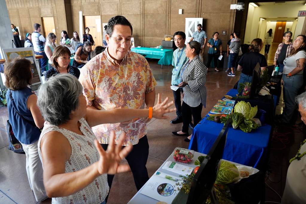 Maui County Soil & Water Conservation District’s Central Maui chair Mae Nakahata talks with Senator Jarrett Keohokalole during Ag Awareness Day Thursday, Feb. 8, 2024, in Honolulu. Reps. Cedric Gates, Kristin Kahaloa and Sens. Mike Gabbard, Tim Richards co-hosted the event. (Kevin Fujii/Civil Beat/2024)