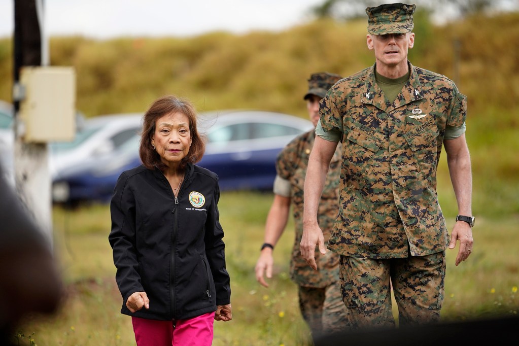 Rep. Rose Martinez and Marine Corps Base Hawaii commanding officer Col. Jeremy Beaven walk toward a briefing to test for metals along the shoreline of the Puuloa Range Training Facility Wednesday, Feb. 14, 2024, in Ewa Beach. Samples will be taken from the makai side of the projectile containment berms for lead and other metals. (Kevin Fujii/Civil Beat/2024)