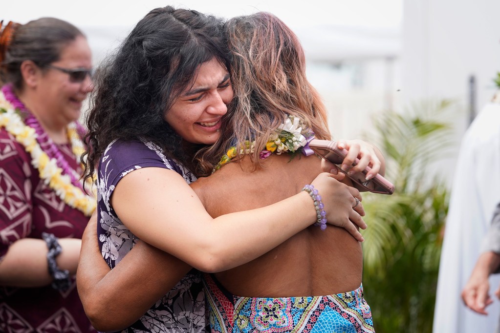 Office on homelessness and housing solutions assistant Vanessa Khachik cries while hugging long-time client and friend Laura Mae after the Ho’okahi Leo Kauhale blessing Thursday, Feb. 15, 2024, in Honolulu. Khachik beamed with pride and happiness her friend will have a place to call home. OHHS calls the kauhale “deeply affordable spaces”. It is intended for tenants to break the cycle of homelessness. (Kevin Fujii/Civil Beat/2024)