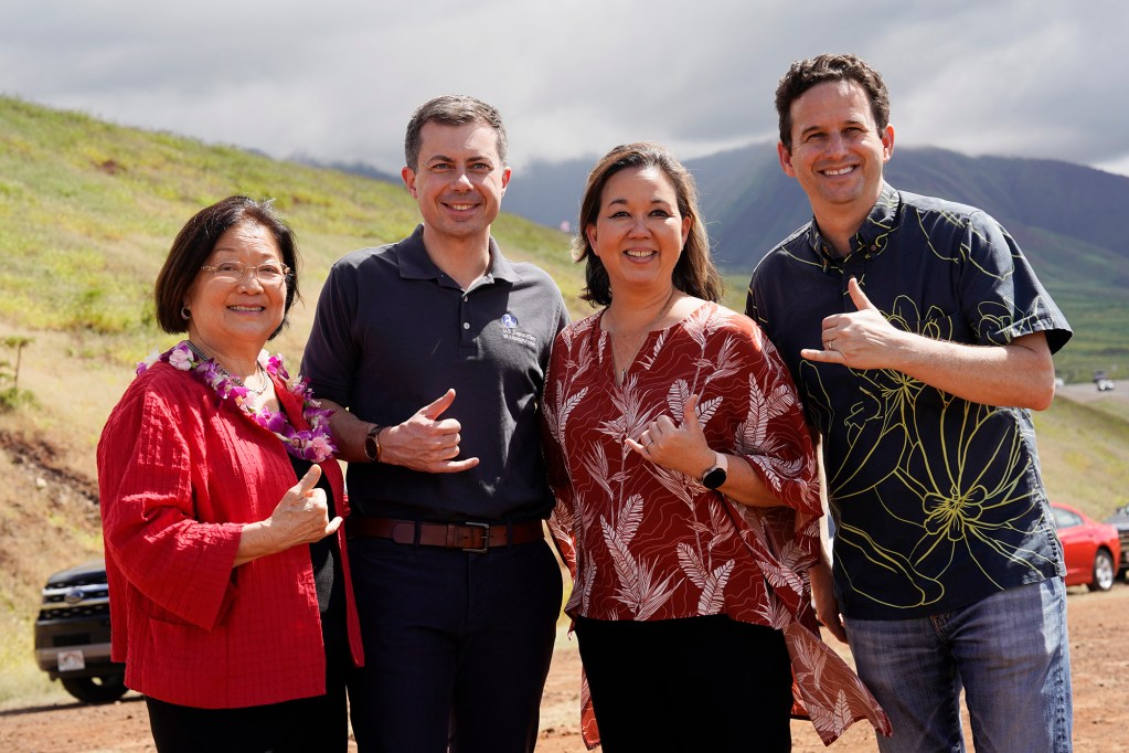 Senator Mazie Hirono, from left, Transportation Secretary Pete Buttigieg, Rep. Jill Tokuda and Sen. Brian Schatz pose for a photo Wednesday, Feb. 21, 2024, in Lahaina. (Kevin Fujii/Civil Beat/2024)