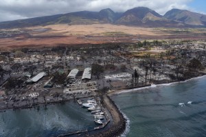 Malu Ulu O Lele Park sits in the upper right corner amid the destruction of Lahania town Thursday, Aug. 10, 2023, in Maui. The park sits on a former fishpond in the Mokuula area. A sheen of oil is also visible inside Lahaina Harbor. (Kevin Fujii/Civil Beat/2023)