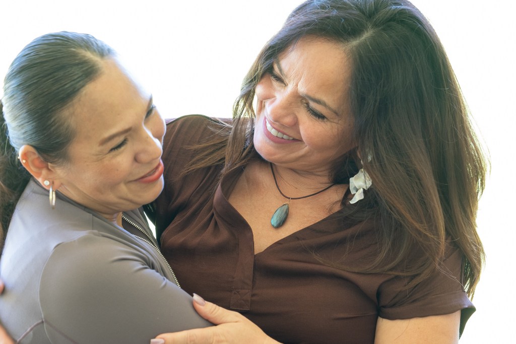 FEMA Interpreter Carolina Davis (brown top) greets Spanish speaking immigrant Victoria Silva at Lahaina Civic Center, Friday March 1st, 2024. The two became acquainted when Victoria  sought assistance through FEMA following the devastating fires of August 8th. (David Croxford/Civil Beat/2024)