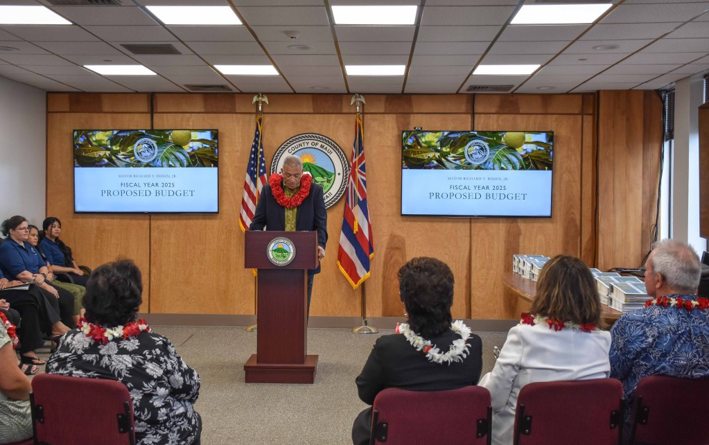 Maui County Mayor Richard Bissen delivers his proposed FY2025 budget of nearly $1.7 billion on Monday to County Council Chair Alice Lee. (Cammy Clark/Civil Beat/2024)