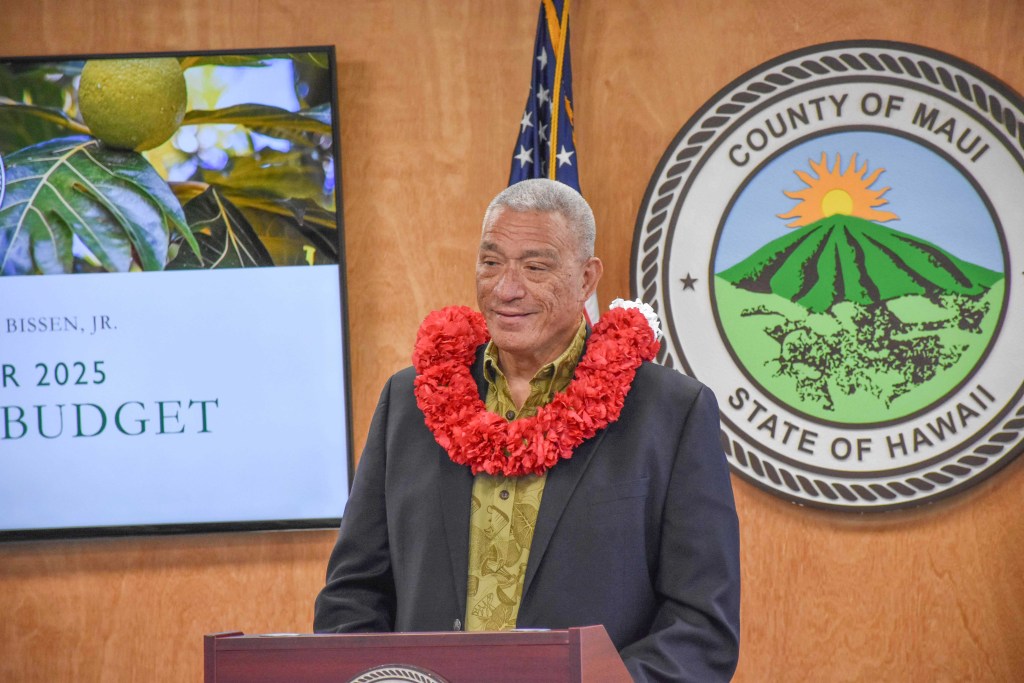 Maui County Mayor Richard Bissen delivers his proposed FY2025 budget of nearly $1.7 billion on Monday to County Council Chair Alice Lee. (Cammy Clark/Civil Beat/2024)