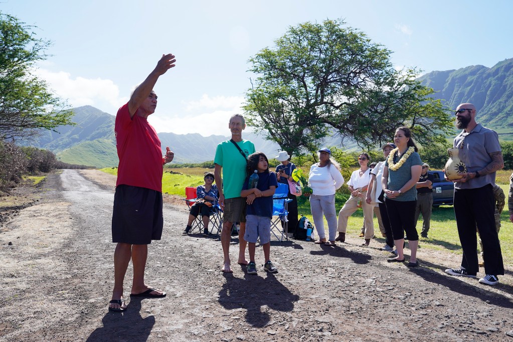 Hui Malama o Makua William “Bill” Aila, Jr., at left, speaks to key stakeholders during the Waiaanae Moku Kupuna Council’s huaka’i (excursion) at Makua Valley’s Makua Military Reservation Thursday, April 25, 2024, in Waianae. This is aimed to give a first person orientation for key participants and community members. (Kevin Fujii/Civil Beat/2024)