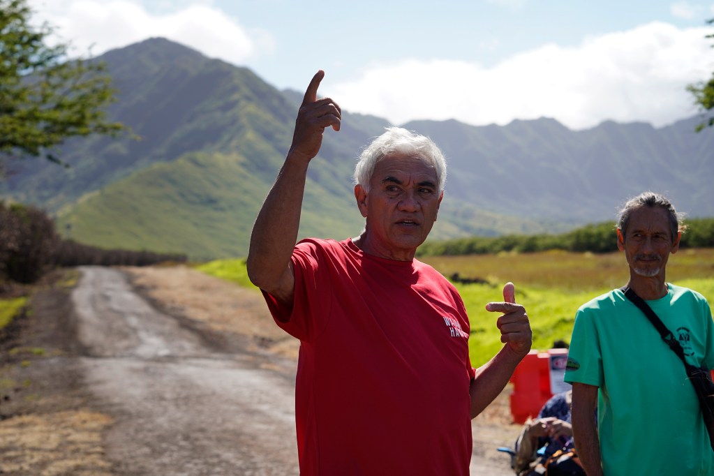 Hui Malama o Makua’s William “Bill” Aila, Jr., describes the three valleys which make up the Makua Military Reservation Thursday, April 25, 2024, in Waianae. This is aimed to give a first person orientation for key participants and community members. Malama Makua Vince Dodge, at right, looks on. (Kevin Fujii/Civil Beat/2024)