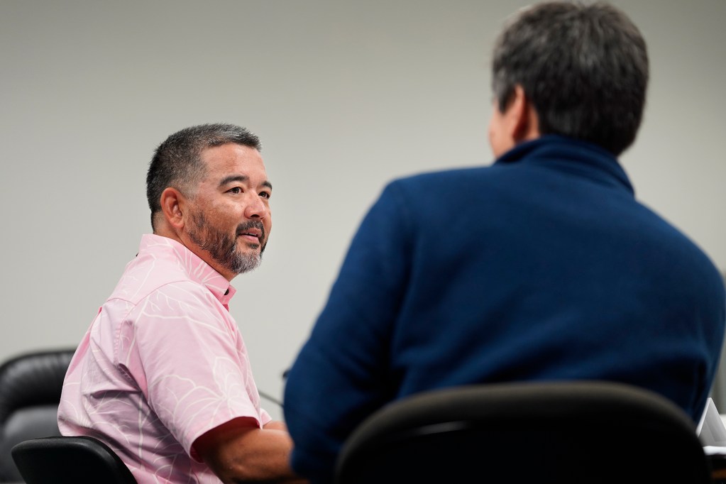 Reps. Andrew Garrett chats with Scot Matayoshi before the Conference Committee reconvenes to resolve differences relating to the procurement for the University of Hawaii on Friday, April 26, 2024, in Honolulu. (Kevin Fujii/Civil Beat/2024)