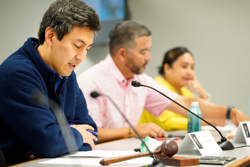 Reps. Scot Matayoshi, from left, Andrew Garrett, Lisa Kitagawa attend the Conference Committee to resolve differences relating to the procurement for the University of Hawaii on Friday, April 26, 2024, in Honolulu. (Kevin Fujii/Civil Beat/2024)