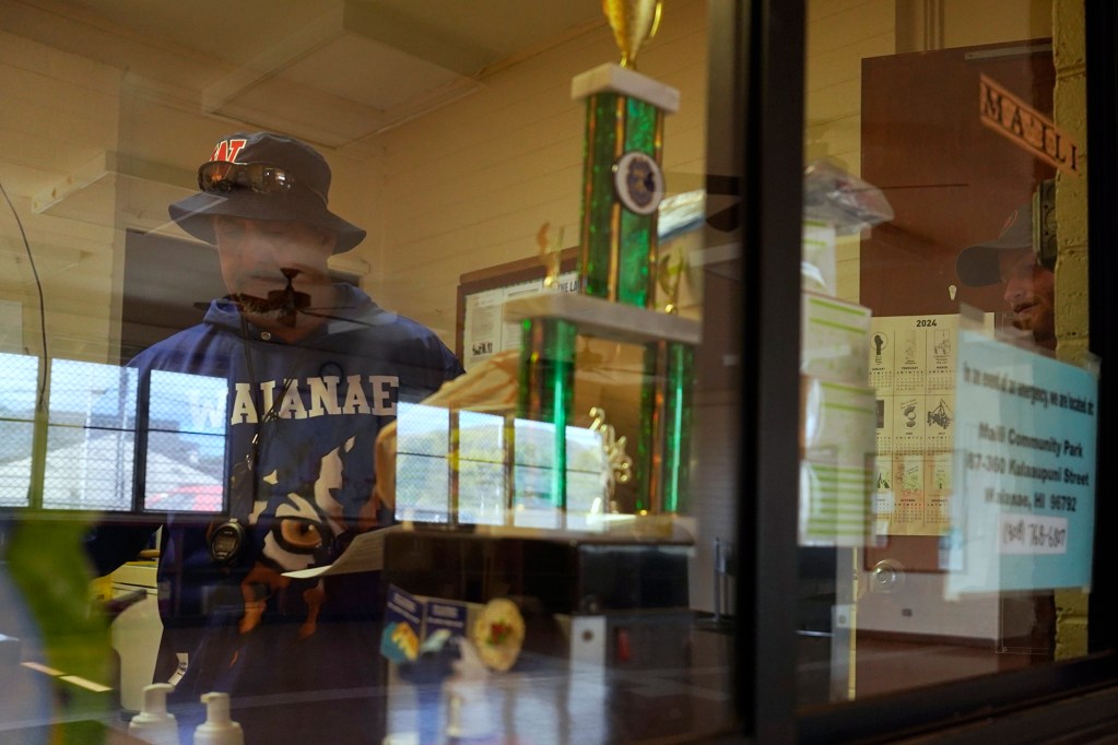Coach Kenny Johnson picks up his permits to practice at Maili Community Park Thursday, May 2, 2024, in Waianae. (Kevin Fujii/Civil Beat/2024)