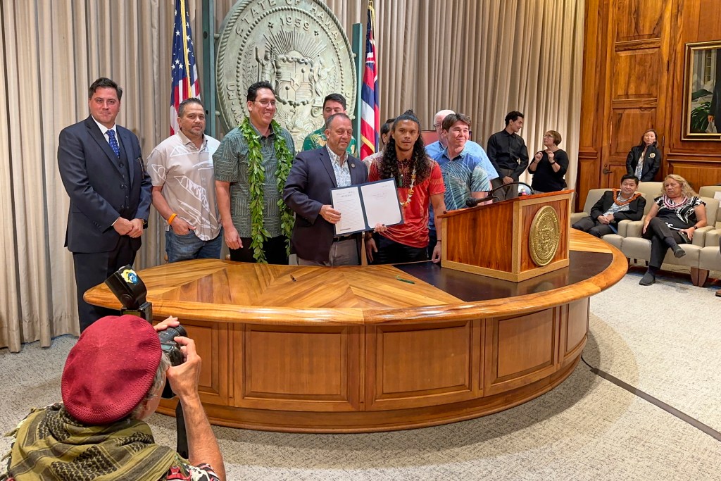 Governor Josh Green signed into law SB2919 on Friday May 3rd, 2024 which addresses the issue of illegal short-term rentals. SB 2919 aims to alleviate Hawaiʻi's housing crisis and increase housing levels throughout the state. This bill provides counties with home rule authority to see that vacation rentals are not allowed in communities that do not want them. It was instigated b y Lahaina Strong a grass roots movement headed by Paele Kiakona who spoke to those witnesses gathered to see the bill signed into law. (David Croxford/Civil Beat/2024)