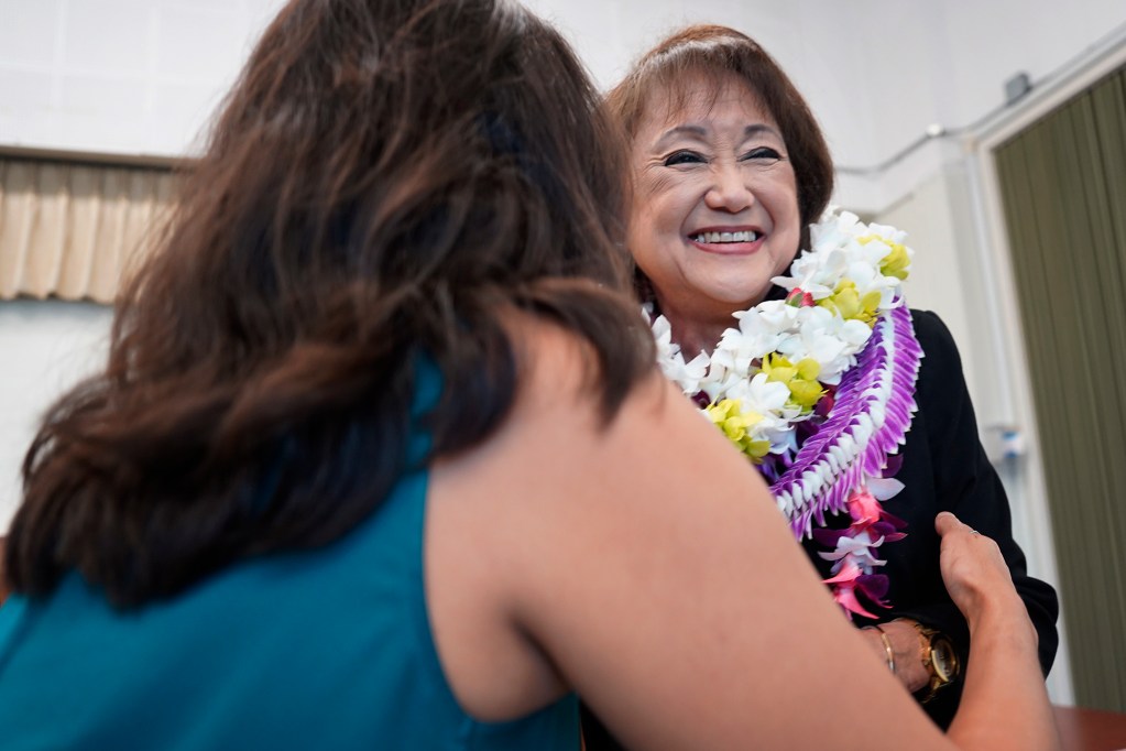 Allison Maertens hugs her mother Elynne Chung after presenting her with a lei before she is sworn onto the Board of Education Thursday, May 9, 2024, in Honolulu. Maertens said, “It’s my turn to be here for my mom since she came to all my sports and events.” (Kevin Fujii/Civil Beat/2024)