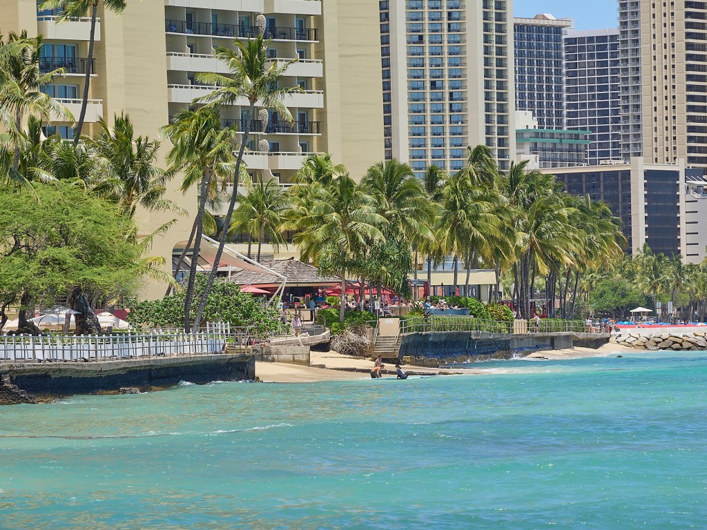 The world famous stretch of beach in Waikiki starts at the Diamond Head end (south) close to the Kaimana Beach Hotel and covers an area toward the Ewa end (north) at the HaleKulani.  Several of them are being inundated and have walkway closures like those shown here on the ocean side of the Outrigger Hotel.(David Croxford/Civil Beat/2024)