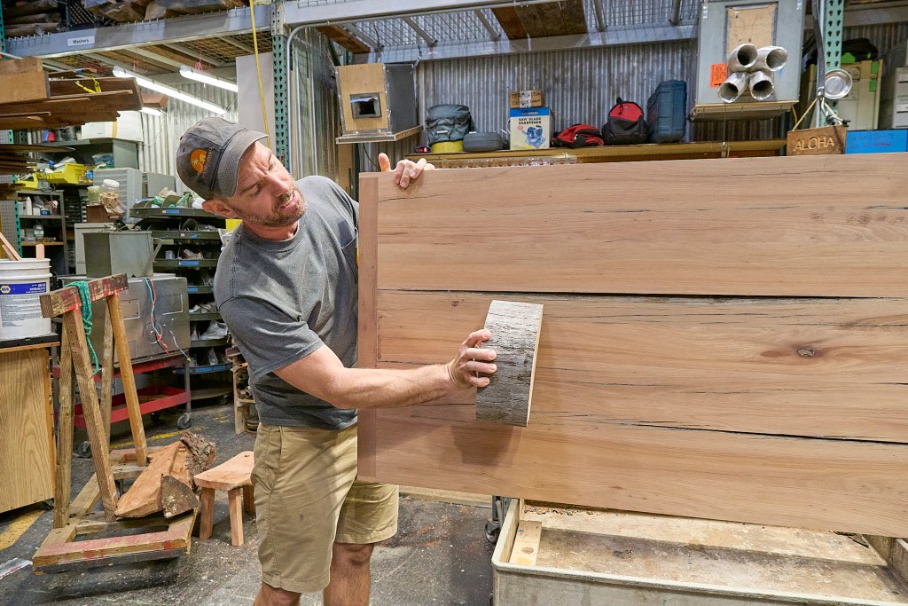 In a warehouse in Kakaako, next to the Waterfront Park is a huge collection of reusable items.  All of them garnered from various deconstruction projects managed by ReUse Hawaii and made available to the public. In House Craftsman Philipp Ziegler demonstrates how trashed wood will often yield usable material for tables, chairs and an assortment of other furniture, photographed May 14th, 2024(David Croxford/Civil Beat/2024)