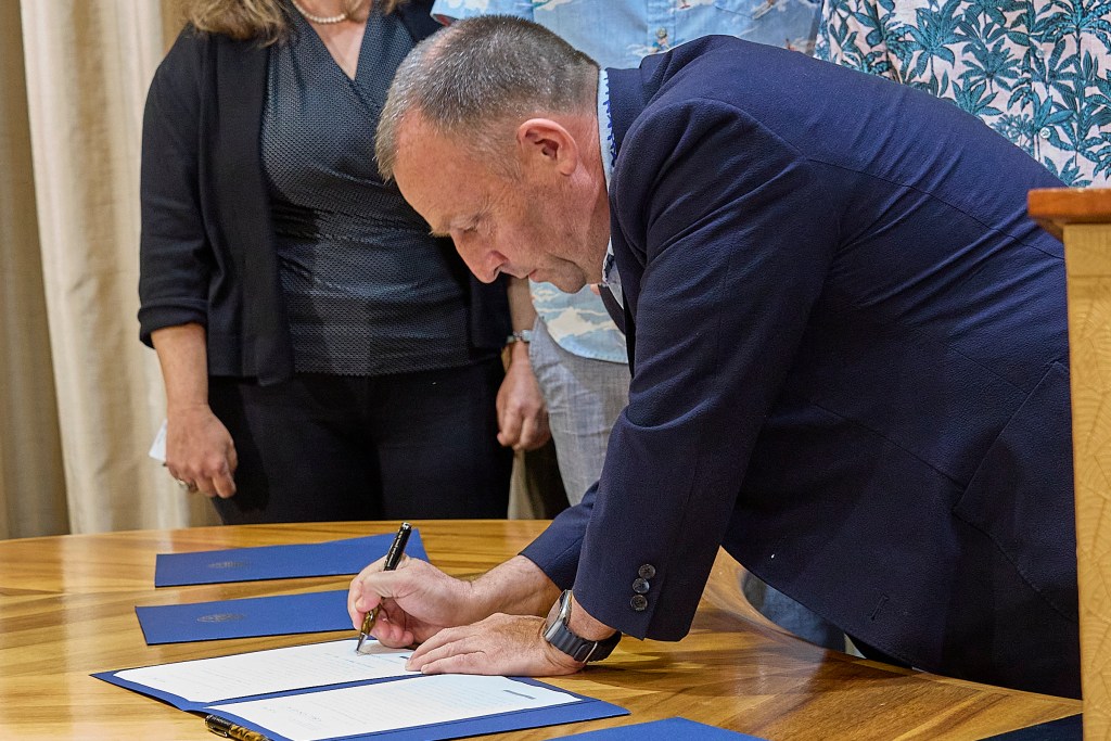 Hawaii Governor Josh Green M.D. signed several Bills into law pertaining to the housing shortage in Hawaii. Several members of his cabinet along with Senator Brian Schatz shared in the moment, Photographed May 28, 2024 (David Croxford/Civil Beat/2024)