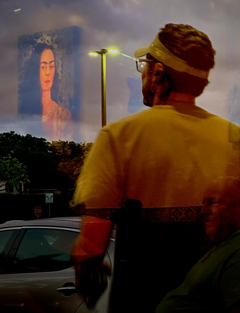 A portrait of artist Frida Kahlo is reflected on the window as customer leaves Frida’s Hawaii Mexican restaurant Sunday, June 2, 2024, in Ewa Beach. (Kevin Fujii/Civil Beat/2024)