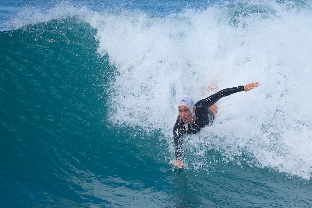 The International Bodysurfing Association held its world championship Tour finals at Point Panics from June 4th to June 14th with competitors from around the world making their appearances. In the Open Women’s quarterfinal held on Monday June 10th DeLori Gomes (purple swim hat), Brooke Roy (Red Swim Hat) and Katie McConnell (White Swim Hat) competed with McConnell taking the windy 0.47 points. All competitors listed their home territory as Polynesia. David Croxford/Civil Beat/2024