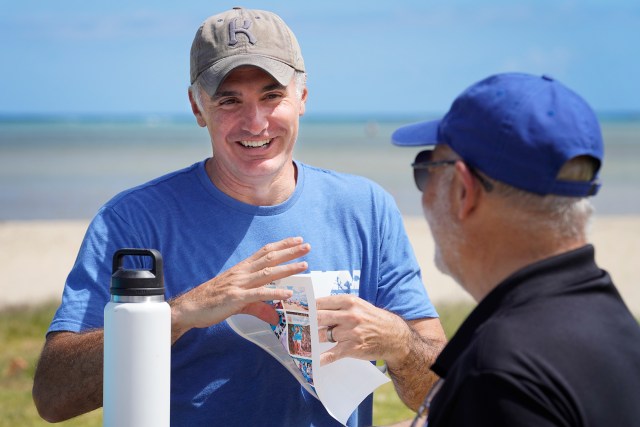 Malama Maunalua executive director Doug Harper, from left, chats with National Oceanic and Atmospheric Administration administrator Dr. Richard Spinrad Tuesday, June 11, 2024, at Kuliʻouʻou Beach Park in Honolulu. Dr. Spinrad is also the U.S. Under Secretary of Commerce for Oceans and Atmosphere. (Kevin Fujii/Civil Beat/2024)