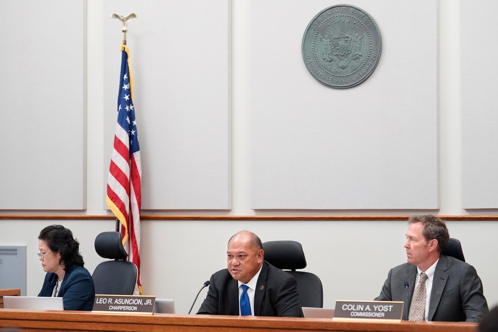 PUC commissioner Naomi Kuwaye, from left, chair Leo Ascuncion, Jr., and commissioner Colin Yost begin a hearing to determine if Sandwich Isles Communications broke any laws Monday, June 17, 2024, in Honolulu. (Kevin Fujii/Civil Beat/2024)