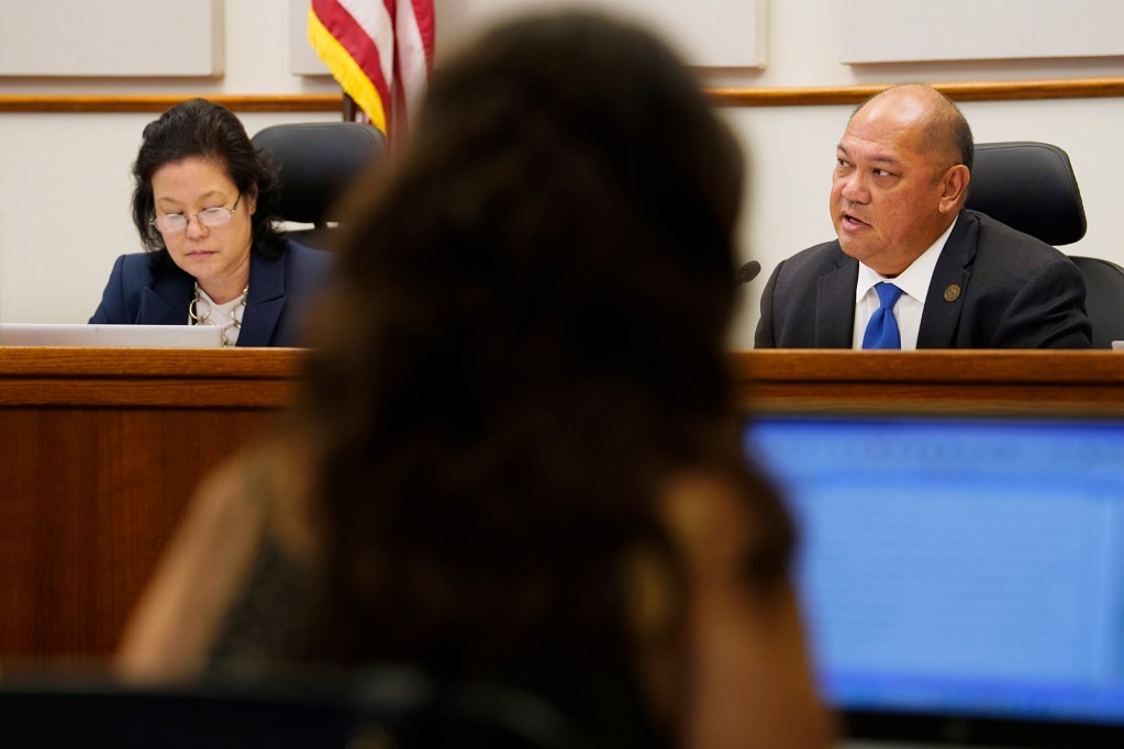 PUC commissioner Naomi Kuwaye, from left, and chair Leo Ascuncion, Jr. hold a hearing to determine if Sandwich Isles Communications broke any laws Monday, June 17, 2024, in Honolulu. (Kevin Fujii/Civil Beat/2024)