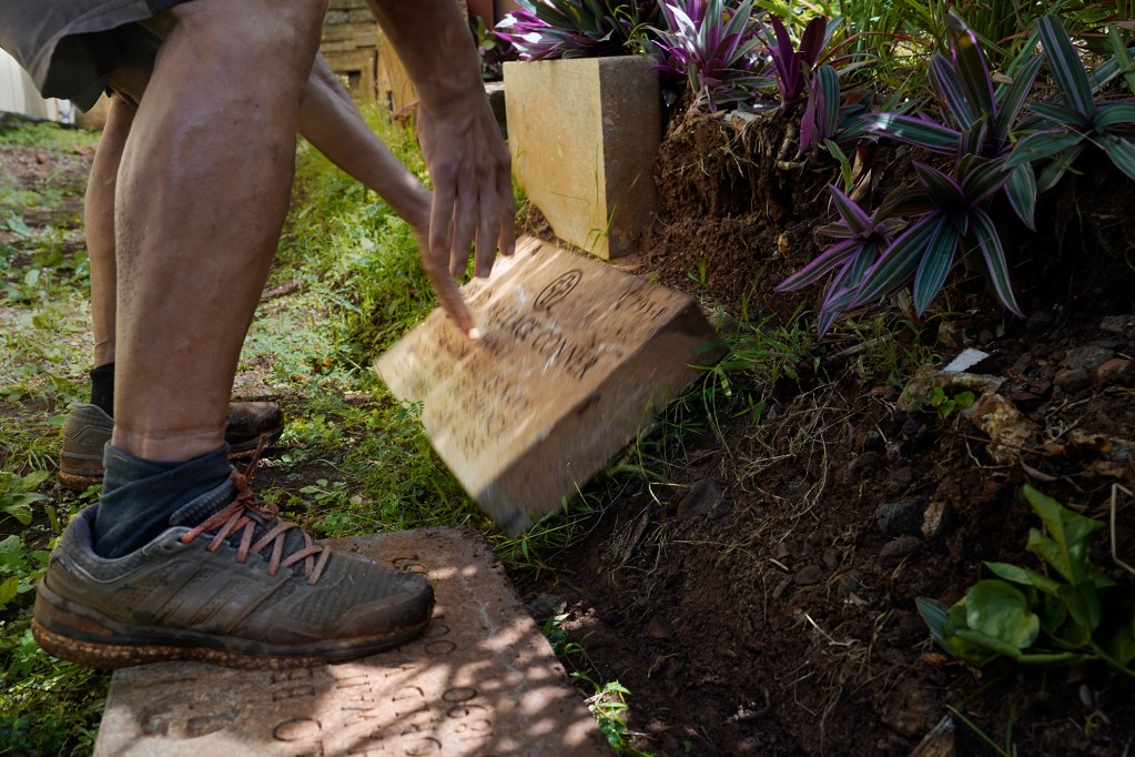 Military grave markers used as landscaping material is moved to show Honolulu Civil Beat journalists Tuesday, June 18, 2024, in Honolulu. (Kevin Fujii/Civil Beat/2024)