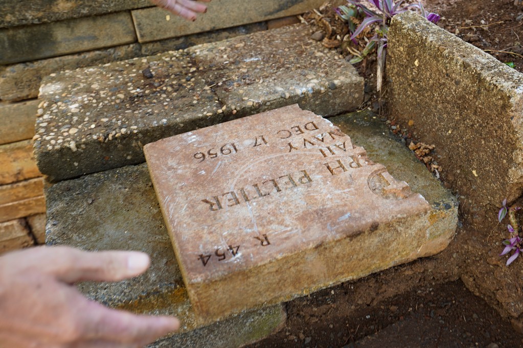 A broken grave marker for U.S. Navy’s Peltier is being used for landscaping material as seen Tuesday, June 18, 2024, in Honolulu. (Kevin Fujii/Civil Beat/2024)