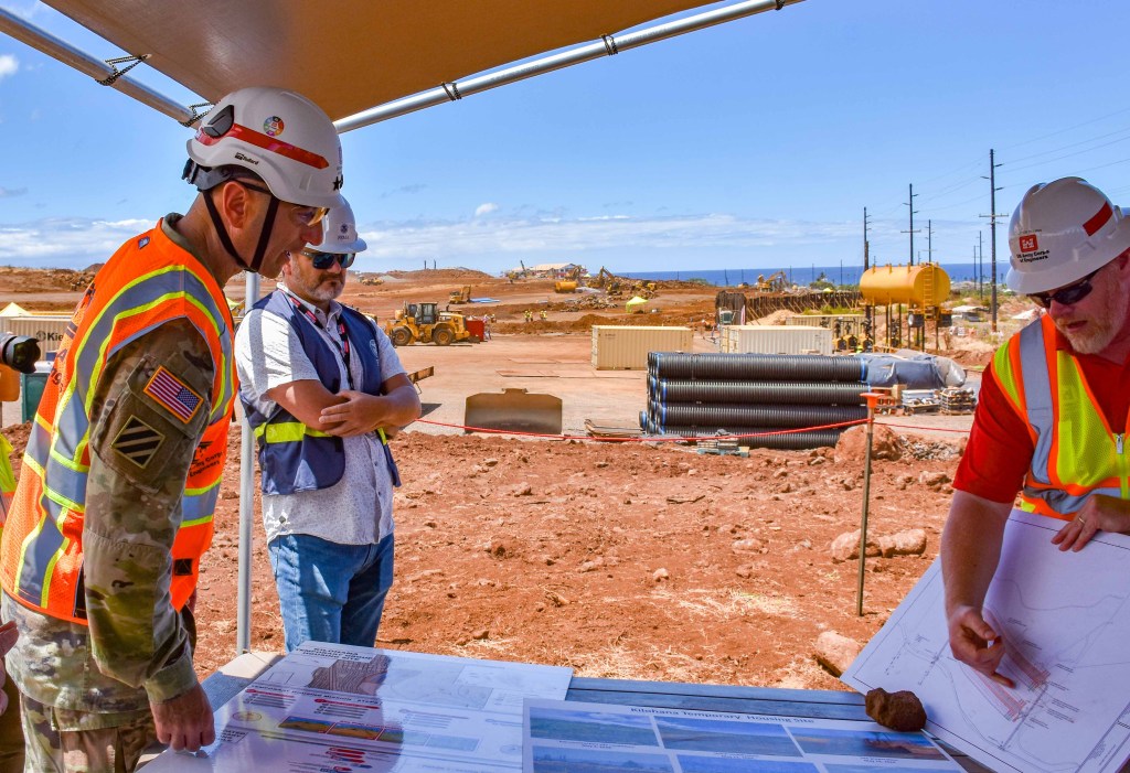 Lt. Gen. Scott Spellmon, commanding general of the Army Corps of Engineers, (left) is briefed on the progress of Kilohana, FEMA's temporary housing complex for fire survivors that the Corps is working on. (Cammy Clark/Civil Beat/2024)