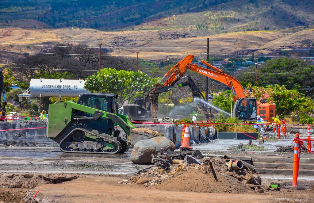 Workers are clearing fire debris from what once was the Outlets of Maui. (Cammy Clark/Civil Beat/2024)