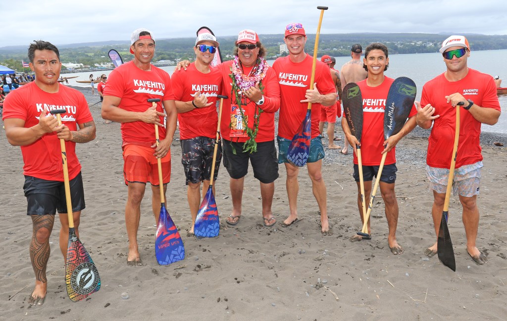 On Saturday, host Kai Ehitu members Trey Cox, Chase Vonnordeim, Keakua Nolan, Isaac Vincent, Ike Sanchis, and Avan Bacerra, along with coach Richard Kiwitete (center), won first place in the Men's freshman bracket at the Kai Ehitu HCRA Regatta at Hilo Bay. Photo: Tim Wright