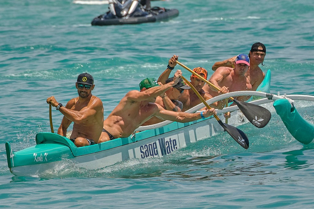 Every 4th of July canoe paddlers from around Oahu join thousands of tourists at Waikiki Beach for the Outrigger Canoe Club’s annual Walter J. Macfarlane Memorial Canoe Regatta. The Macfarlane Regatta is the only wave race on the Oahu Hawaiian Canoe Racing Association schedule and is the oldest annual outrigger canoe race in the world, getting its start in 1943.(David Croxford/Civil Beat/2024)