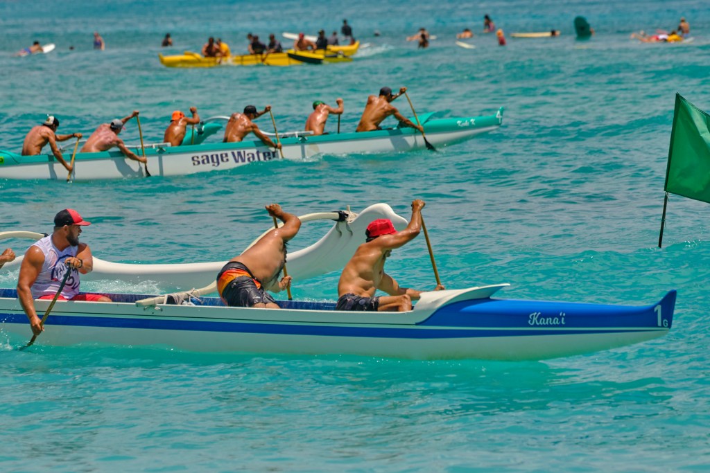 Every 4th of July canoe paddlers from around Oahu join thousands of tourists at Waikiki Beach for the Outrigger Canoe Club’s annual Walter J. Macfarlane Memorial Canoe Regatta. The Macfarlane Regatta is the only wave race on the Oahu Hawaiian Canoe Racing Association schedule and is the oldest annual outrigger canoe race in the world, getting its start in 1943.(David Croxford/Civil Beat/2024)