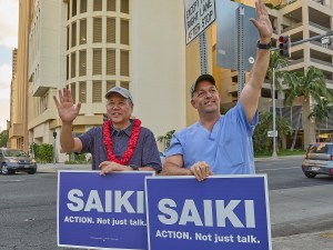 Hawaii Speaker of the House Scott Saiki was joined on Friday afternoon by Hawaii Gov. Josh Green at the corner of South Beretania and Alakea streets to sign wave during afternoon drive time. July 5th, 2024 (David Croxford/Civil Beat/2024)