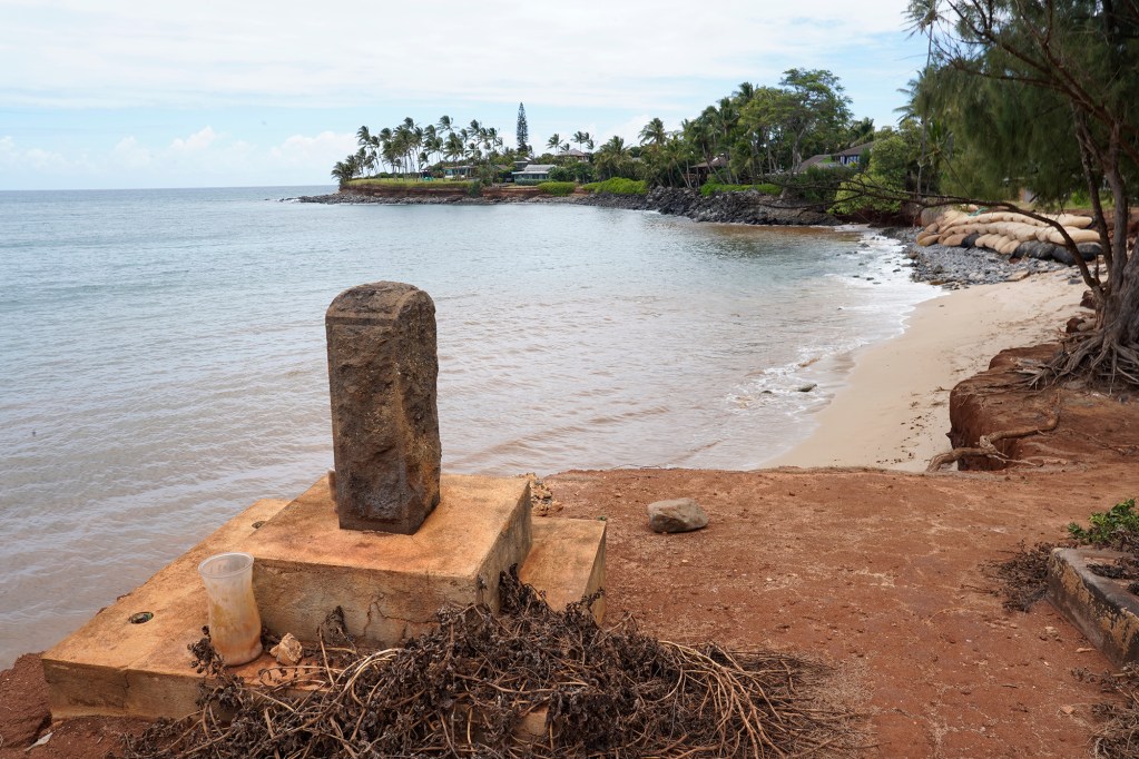 A grave marker sits on the new edge of the Paia Mantokuji Soto Mission cemetery Saturday, July 20, 2024, in Paia. The Soto Zen Buddhist temple was founded in 1906 on Maui’s North Shore. Land upon which the mission sits is eroding into the Pacific Ocean. (Kevin Fujii/Civil Beat/2024)