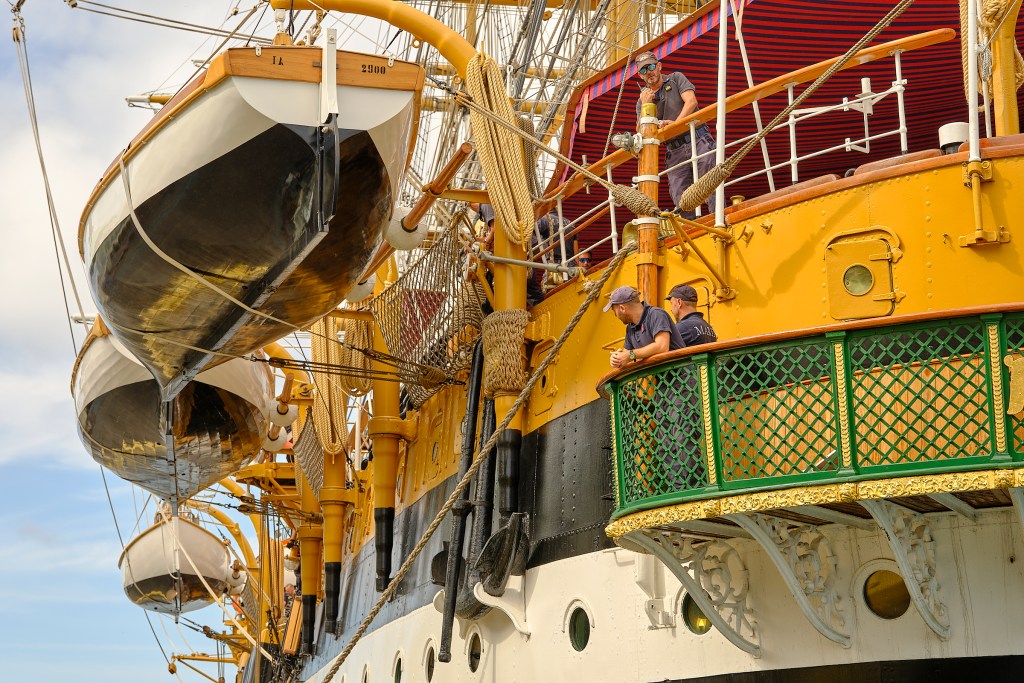 Crew members of The Amerigo Vespucci ship, watch as the vessel is moved to berth at the Aloha Tower pier. Under the command of Captain Giuseppe Lai, the ship is the longest-serving unit of the Italian Navy, boasting 93 years of service. Its stop in Honolulu is part of its second undertaking to circumnavigate the globe. The deployment will keep it at sea for 20 months, visiting total 36 ports in 32 different countries. (David Croxford/Civil Beat/2024)
