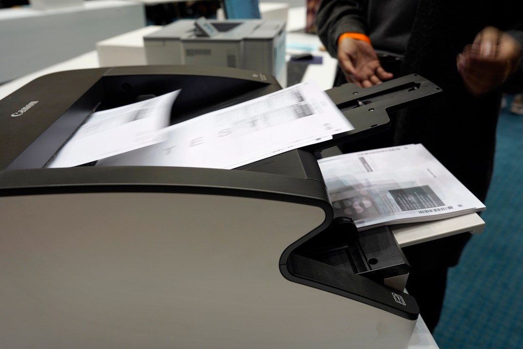 Test ballots are scanned and counted during the Office of Elections test of the vote counting system to prepare for the primary election Saturday, July 27, 2024, in the Hawaii State Capitol Senate Chambers in Honolulu. (Kevin Fujii/Civil Beat/2024)